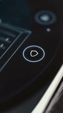 White outlined shield button glows beside the edge of a dark rectangular Fotos Stock