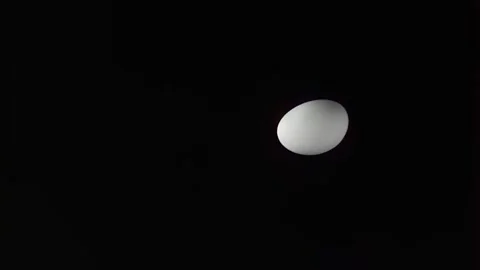 White Oval Sphere Floating Above Black Surface Stock Footage 339301763