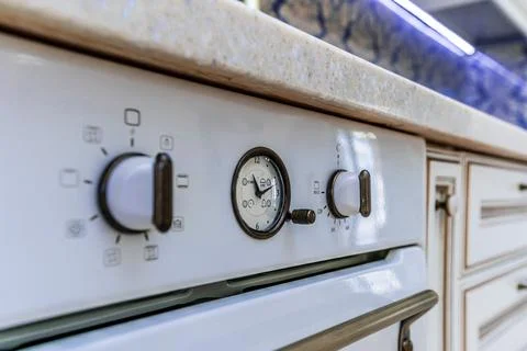 A white oven with a clock on the front Stock Photos