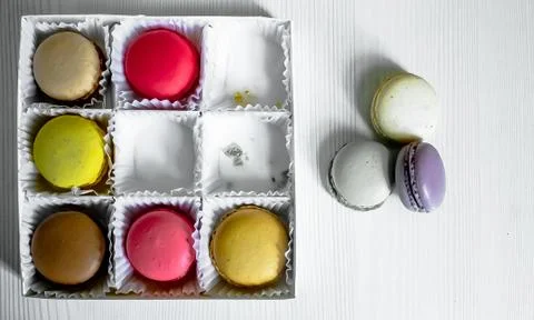 White pack with Macarons cookie, on a white wooden background. View from above Stock Photos