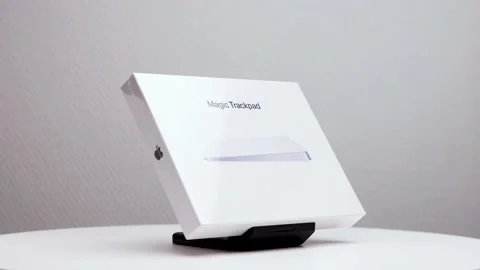 White package box of Mac magic trackpad on display stand with Apple Stock Footage 176458088