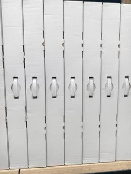 White packaging boxes with handles displayed in structured rows on electron.. Stock Photos