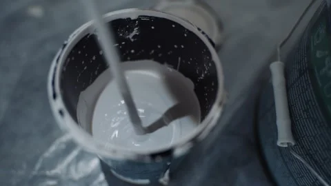 White paint being stirred in open bucket Vídeos de archivo 312227100