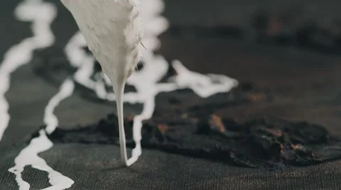 White paint dripping from brush Stock Footage 64764000