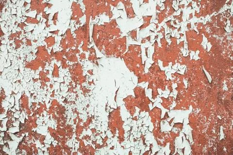 White paint flaking and cracking texture on rusty metal. Stock Photos
