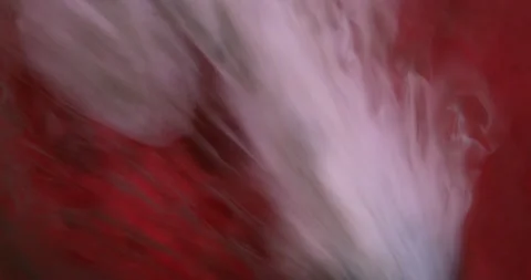 White Paint Flows Across a Red Background Stock Footage 223254150
