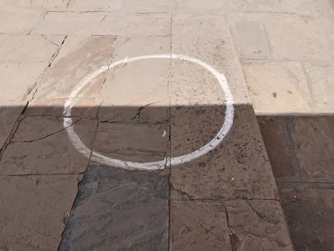 White painted circles on the stone pathway and stairs near ticket counter. Stock Photos