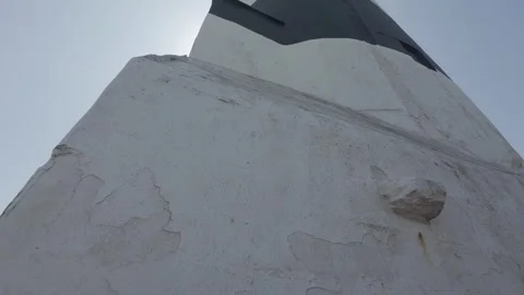 White painted lighthouse base and tower in ireland Stock Footage 340469560