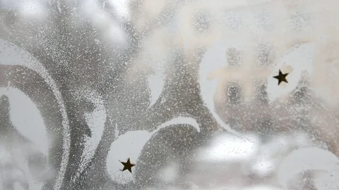 White painted patterns with gold stars on a clear glass Stock Footage 99934803
