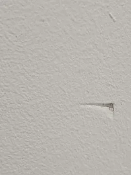White Painted Wall Texture with Small Paint Chip and Copy Space Фото