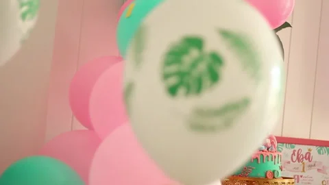 White with palm leaves pattern and pink air balloons close up focus shot Stock Footage 202213748