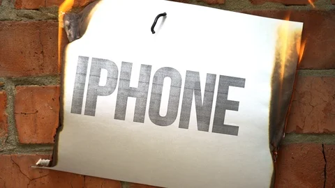White paper A4 size burn, smoke on brick wall with word Iphone. Concept of war. Stock Footage 108756520