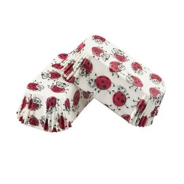 White paper baking forms for cakes with ladybirds pattern Stock Photos