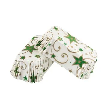 White paper baking forms for cakes with green stars pattern Stock Photos