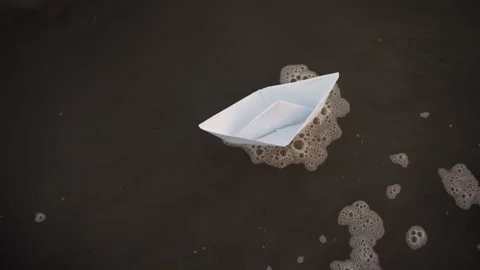 White Paper Boat Floating on Dark Liquid with Soap Bubbles featuring origami Stock Footage 346734034