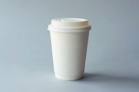 White paper cup on a gray background minimalism Stock Photos