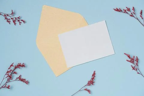 White paper list with envelope in a frame of flowers on blue background from  Stock Photos