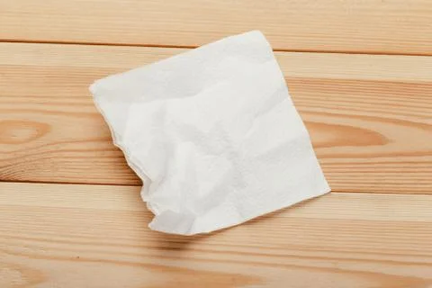 White paper napkin with a textured pattern on an old table Stock Photos