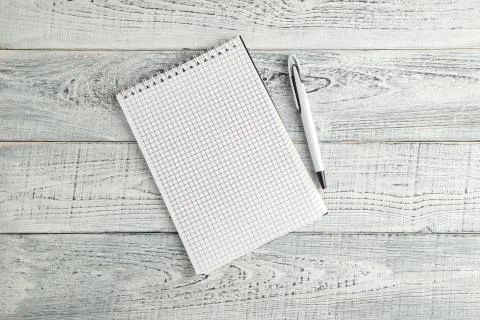 White paper Notepad and white pen on vintage shabby white wooden background Stock Photos