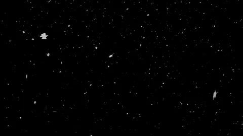 White paper scraps and particles falling on black background 库存影片 344654714