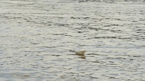 White Paper Ship is Floating by Water Distantly Childish Amusement Game Dream Stock Footage 64774337