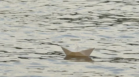 White Paper Ship is Floating by Water Childish Amusement Game Dream Surface Stock Footage 64774520
