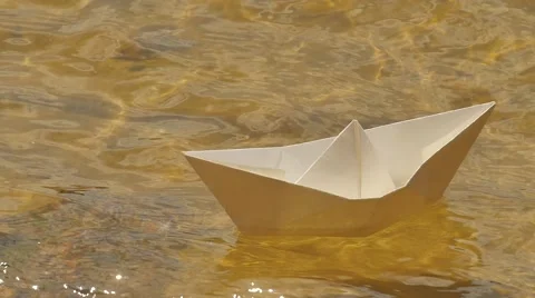 White Paper Ship is Floating by Water Sunny Day Childish Amusement Game Dream Stock Footage 64774544