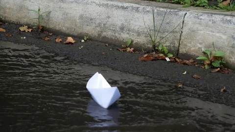 White paper ship in a rain stream Stock Footage 78478554