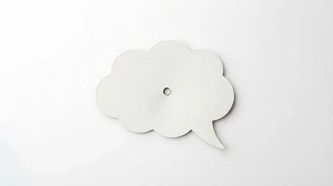 White paper speech bubble cutout on a clean background for communication co.. Stock Photos