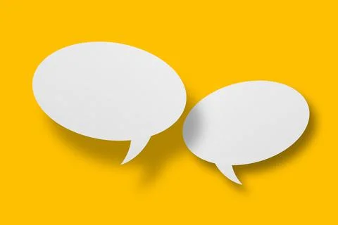 White paper in speech bubble shape set against yellow background. Stock Photos
