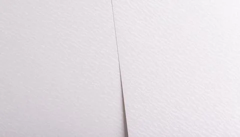 White paper texture with a soft, smooth surface and subtle wavy patterns. The Stock Photos