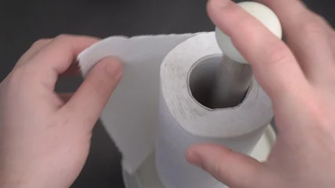 White paper towels on a black table. tear off a piece Видео 128028531