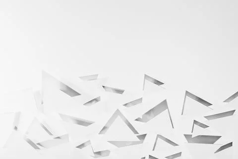 White paper triangles different size soar as abstract random pattern in brigh Stock Photos