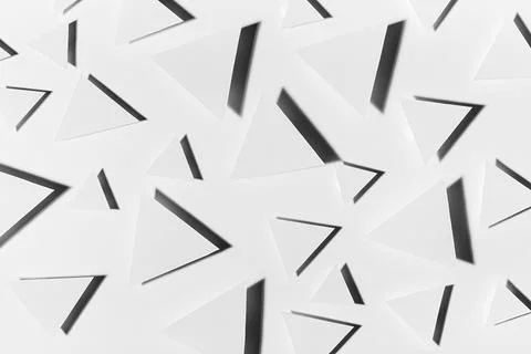 White paper triangles different size as abstract random pattern in bright lig Stock Photos