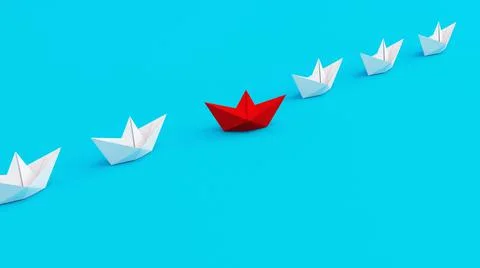White paperboats in one direction with one red paperboat changing direction on Stock Photos