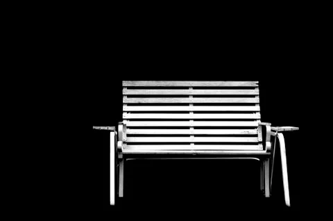 White park bench with solid black background Foto stock