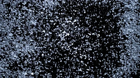 White particles exploding on black background Video stock 229455535