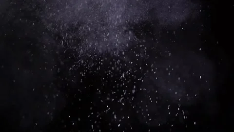 White particles fall beautifully against a black background Stock Footage 144113299