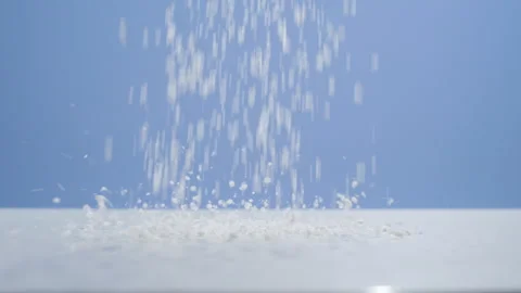 White Particles Falling Against Blue Background Studio Shot Stock Footage 340245000