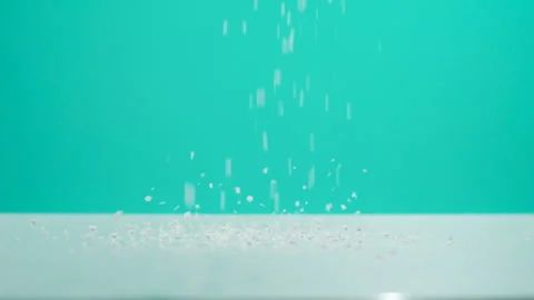 White Particles Falling Against Teal Green Background Studio Stock Footage 340244991