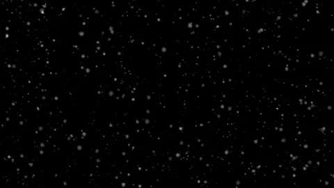 White particles gently fall against a deep black background, creating an Stock Footage 343339488