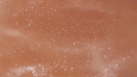 White particles swirling and glittering against a warm brown backdrop Video stock 343938540