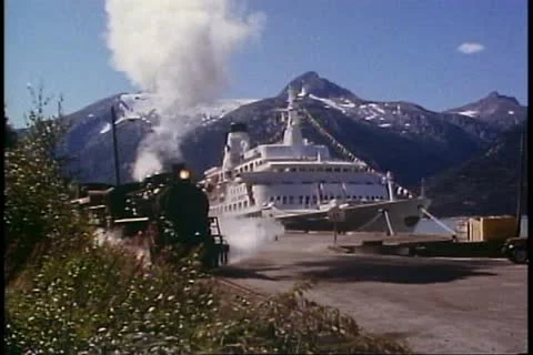White Pass & Yukon Railroad, Alaska, steam engine passes, ship behind Stock Footage