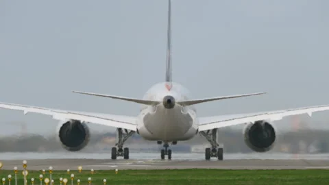 White passenger aircraft accelerating runway during takeoff roll, rear close up Stockbeeldmateriaal 333646812