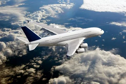 White passenger double decker plane fly over the clouds Stock Photos