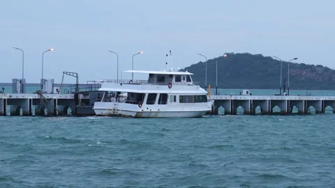 White passenger ferry boat docked at concrete pier jetty in calm blue ocean Video stock 342916551