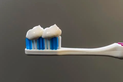 White paste smeared on a toothbrush Stock Photos