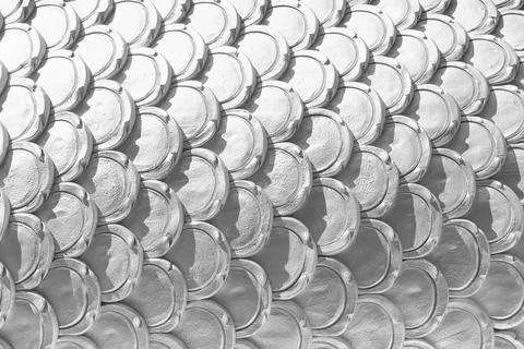 White patterns of stucco shaped like fish scales. Stock Photos