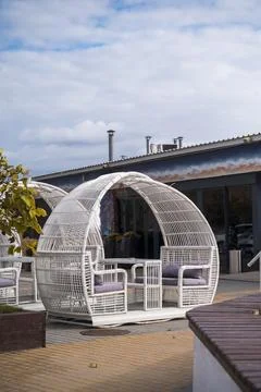 White pavilion for rest and dining in an urban park. Modern outdoor booth with Stock Photos
