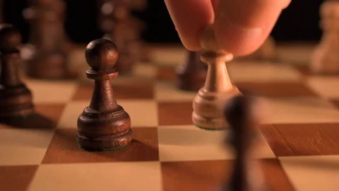 White pawn piece strikes down black pawn in chess match 스톡 동영상 116270296